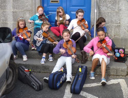 Irish traditional music played in the street during a spontaneous session at Tulla Trad, County Clare, Ireland.