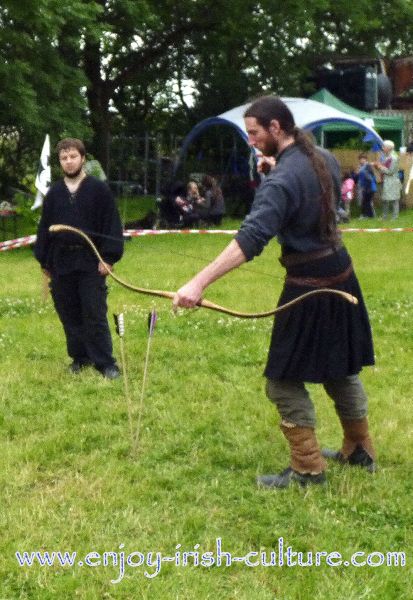 Medieval Ireland- Irish warrior with the special shaped Irish bow and arrows with metal tips, reenacted by Eireann Edge.