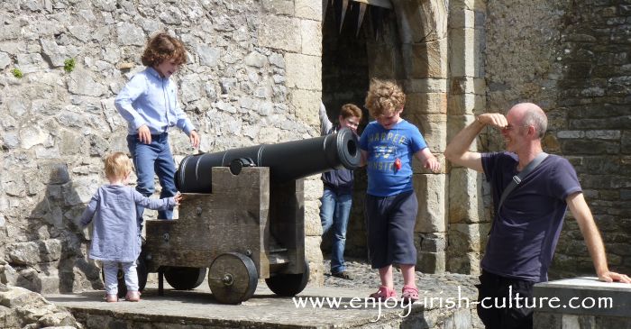 Kids of all ages having fun with a cannon at Cahir Castle, County Tipperary, Ireland.