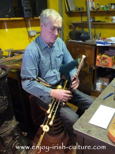 Irish musician and instrument maker Eugene Lambe, playing the uilleann pipes at his workshop in Kinvara, County Galway, Ireland.