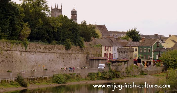 Walk along the river Nore following the curtain wall of the castle, with a view of the town of Kilkenny, Ireland.