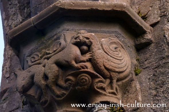 Abbey at Boyle, County Roscommon, Ireland, decorative medieval stone carvings of peacock and wild cats fighting over ahuman head.