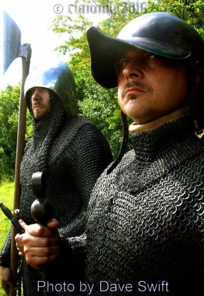 Galloglaigh warriors of medieval Ireland wearing typical helmets and carrying their traditional weapons.