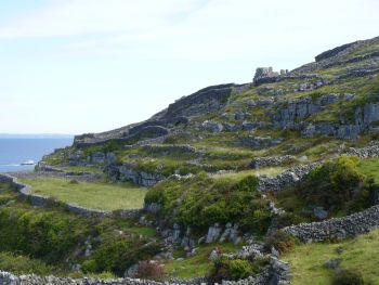 Inisheer landscape, County Galway, Ireland with the ruin of the medieval O'Flaherty castle on top of the hill.