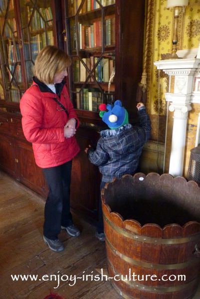 In the drawing room at Strokestown Park House, County Roscommon, Ireland, where our six year old son is getting ready to ring the servant's bell.