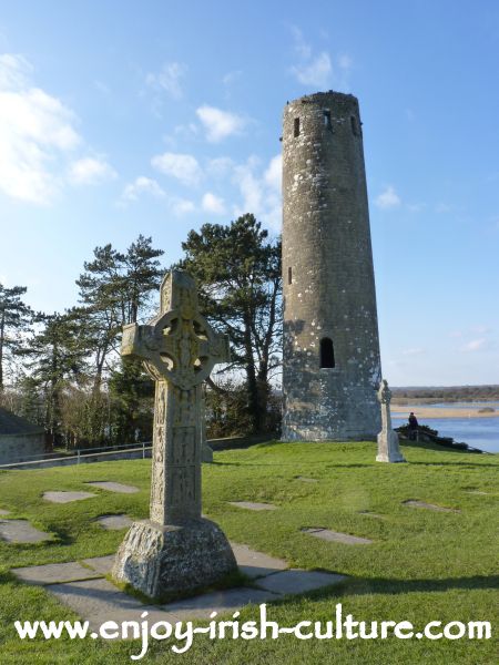 Clonmacnoise, County Offaly, Ireland, Replica of the Cross of the scriptures and round tower.