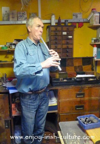 Irish musician and instrument maker Eugene Lambe playing a low whistle.