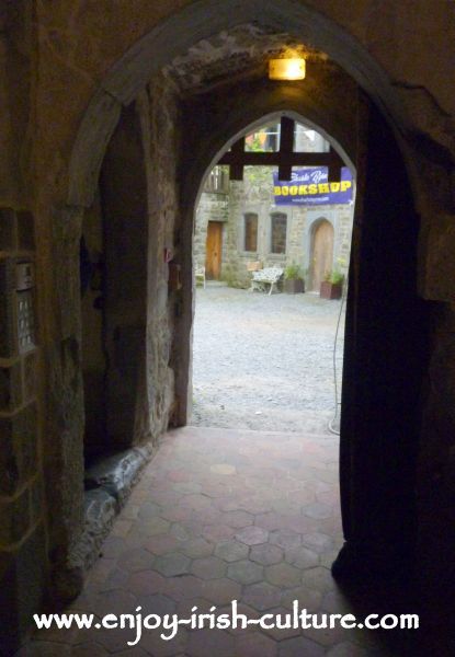 The entrance with portcullis and heavy wooden door at Claregalway Castle, County Galway, Ireland.